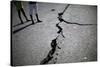 Children Walk Past a Crack Caused by the Earthquake in a Street in Port-Au-Prince-Carlos Barria-Stretched Canvas