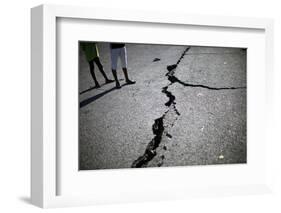Children Walk Past a Crack Caused by the Earthquake in a Street in Port-Au-Prince-Carlos Barria-Framed Photographic Print