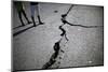 Children Walk Past a Crack Caused by the Earthquake in a Street in Port-Au-Prince-Carlos Barria-Mounted Photographic Print