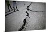 Children Walk Past a Crack Caused by the Earthquake in a Street in Port-Au-Prince-Carlos Barria-Mounted Photographic Print