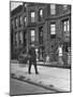 Children Watching a Policeman Walk His Beat in Front of Apartment Buildings-Ed Clark-Mounted Photographic Print