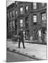 Children Watching a Policeman Walk His Beat in Front of Apartment Buildings-Ed Clark-Mounted Photographic Print