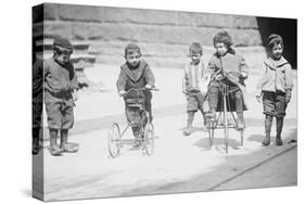 Children With Tricycles Playing In Manhattan Street-null-Stretched Canvas