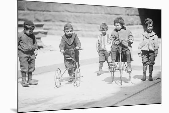 Children With Tricycles Playing In Manhattan Street-null-Mounted Art Print