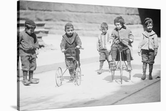 Children With Tricycles Playing In Manhattan Street-null-Stretched Canvas