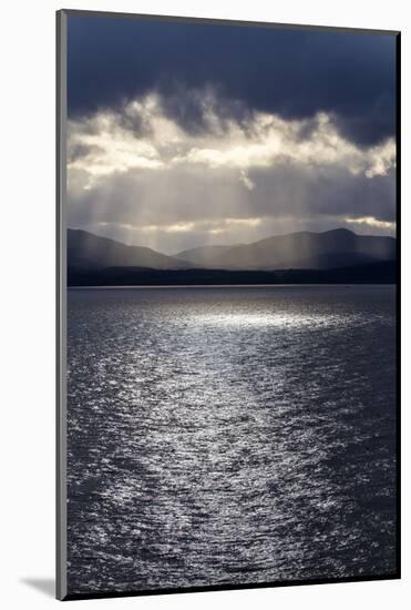 Chile, Patagonia, Strait of Magellan. Tierra del Fuego, rays of sunshine over the fjords and sea.-Jolly Sienda-Mounted Photographic Print