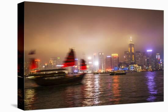 China, Hong Kong, Nightly Light Show of the City of Hong Kong Draped in Fog and Moving Sailboat-Terry Eggers-Stretched Canvas