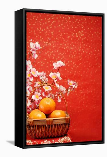 Chinese New Year Decoration--A Basket of Oranges with Plum Flower on a Festive Background.-Liang Zhang-Framed Stretched Canvas