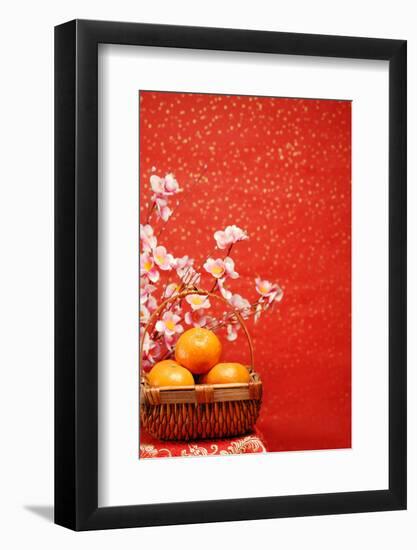 Chinese New Year Decoration--A Basket of Oranges with Plum Flower on a Festive Background.-Liang Zhang-Framed Photographic Print