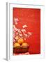 Chinese New Year Decoration--A Basket of Oranges with Plum Flower on a Festive Background.-Liang Zhang-Framed Photographic Print