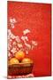 Chinese New Year Decoration--A Basket of Oranges with Plum Flower on a Festive Background.-Liang Zhang-Mounted Photographic Print