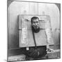 Chinese Prisoner in the Cangue Placarded with the Record of His Crime, China, 1902-CH Graves-Mounted Photographic Print