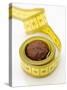 Chocolate Truffle Lying in Rolled-Up Tape Measure-Elisabeth Cölfen-Stretched Canvas