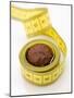 Chocolate Truffle Lying in Rolled-Up Tape Measure-Elisabeth Cölfen-Mounted Photographic Print