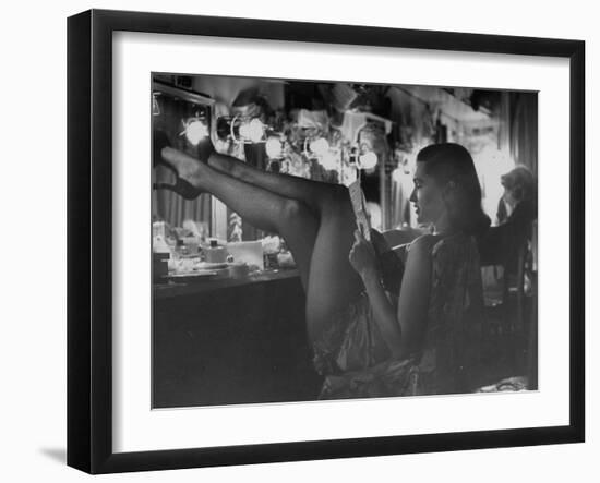 Chorus Girl-Singer Linda Lombard, Resting Her Legs after a Tough Night on Stage-George Silk-Framed Premium Photographic Print