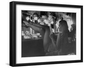 Chorus Girl-Singer Linda Lombard, Resting Her Legs after a Tough Night on Stage-George Silk-Framed Photographic Print