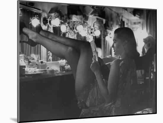 Chorus Girl-Singer Linda Lombard, Resting Her Legs after a Tough Night on Stage-George Silk-Mounted Photographic Print