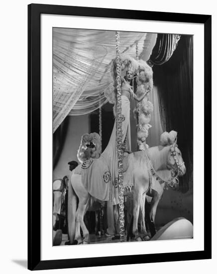 Chorus Girl Standing on Horse's Back During Filming of the Movie "The Ziegfeld Follies"-John Florea-Framed Photographic Print