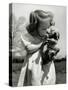 Christina Goldsmith Kissing a Weimaraner Puppy from Her Father's Stock of Weimaraner Hunting Dogs-Bernard Hoffman-Stretched Canvas