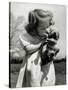 Christina Goldsmith Kissing a Weimaraner Puppy from Her Father's Stock of Weimaraner Hunting Dogs-Bernard Hoffman-Stretched Canvas