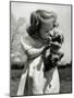 Christina Goldsmith Kissing a Weimaraner Puppy from Her Father's Stock of Weimaraner Hunting Dogs-Bernard Hoffman-Mounted Photographic Print