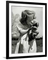 Christina Goldsmith Kissing a Weimaraner Puppy from Her Father's Stock of Weimaraner Hunting Dogs-Bernard Hoffman-Framed Photographic Print