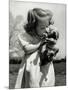 Christina Goldsmith Kissing a Weimaraner Puppy from Her Father's Stock of Weimaraner Hunting Dogs-Bernard Hoffman-Mounted Photographic Print