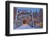 Christmas decorations adorn the historic one lane Swan River Bridge in Bigfork, Montana, USA-Chuck Haney-Framed Photographic Print