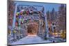 Christmas decorations adorn the historic one lane Swan River Bridge in Bigfork, Montana, USA-Chuck Haney-Mounted Photographic Print