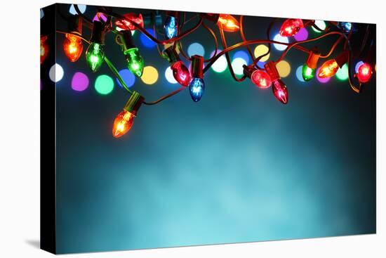 Christmas Lights over Dark Blue Background-Sofiaworld-Stretched Canvas