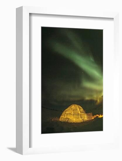 Churchill, Manitoba, Canada. Northern Lights shine above lit igloo.-Yvette Cardozo-Framed Photographic Print