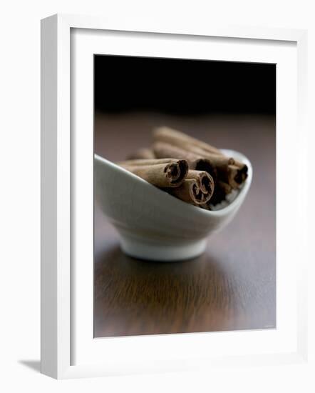 Cinnamon Sticks in Small Bowl-Henrik Freek-Framed Photographic Print