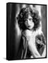 circa, 1929: Hollywood film star, Clara Bow (1905 - 1965) poses in a cape with jewelled clasp (b/w-null-Framed Stretched Canvas