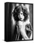 circa, 1929: Hollywood film star, Clara Bow (1905 - 1965) poses in a cape with jewelled clasp (b/w-null-Framed Stretched Canvas