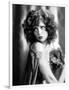 circa, 1929: Hollywood film star, Clara Bow (1905 - 1965) poses in a cape with jewelled clasp (b/w-null-Framed Photo