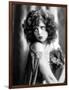 circa, 1929: Hollywood film star, Clara Bow (1905 - 1965) poses in a cape with jewelled clasp (b/w-null-Framed Photo