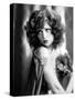circa, 1929: Hollywood film star, Clara Bow (1905 - 1965) poses in a cape with jewelled clasp (b/w-null-Stretched Canvas