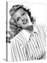 circa, 1942: Portrait of American actor Rita Hayworth (1918 - 1987) wearing a striped shirt (b/w ph-null-Stretched Canvas