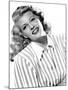 circa, 1942: Portrait of American actor Rita Hayworth (1918 - 1987) wearing a striped shirt (b/w ph-null-Mounted Photo