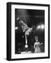 Circus Performer Balancer Unus Standing on His Index Finger on Globe Feet in Air Back of Head-Ralph Morse-Framed Photographic Print