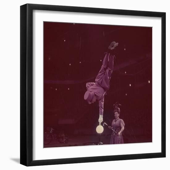 Circus Performer Balancing on Forefinger-Ralph Morse-Framed Photographic Print