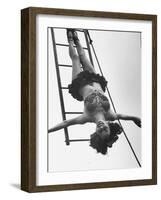 Circus Performer Hanging Upside Down-Cornell Capa-Framed Photographic Print