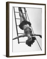 Circus Performer Hanging Upside Down-Cornell Capa-Framed Photographic Print