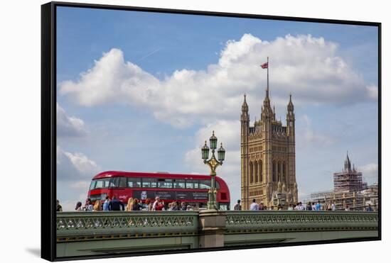 Classic double decker tour bus in London, England crossing the bridge River Thames-Michele Niles-Framed Stretched Canvas