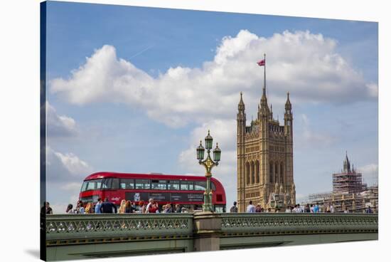 Classic double decker tour bus in London, England crossing the bridge River Thames-Michele Niles-Stretched Canvas