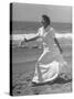 Claudette Colbert in Zippered, Terry Cloth Beach Robe, Sashaying Along Surf at Santa Monica Beach-Peter Stackpole-Stretched Canvas