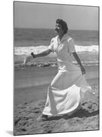 Claudette Colbert in Zippered, Terry Cloth Beach Robe, Sashaying Along Surf at Santa Monica Beach-Peter Stackpole-Mounted Premium Photographic Print