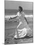 Claudette Colbert in Zippered, Terry Cloth Beach Robe, Sashaying Along Surf at Santa Monica Beach-Peter Stackpole-Mounted Premium Photographic Print