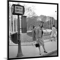 Claudia Cardinale Waiting Near the Champs-Elysées Roundabout, April 1964-Marcel Begoin-Mounted Photographic Print