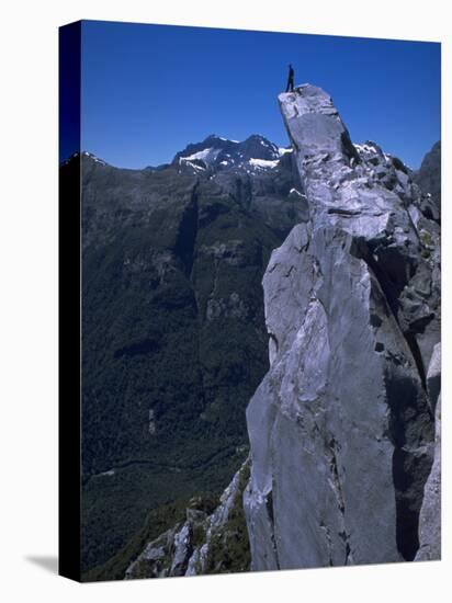 Climber on the Summit of a Rock Tower, Chile-Pablo Sandor-Stretched Canvas